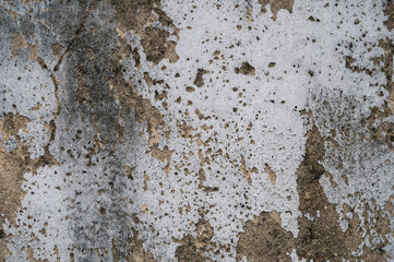 A weathered concrete wall with peeling white and gray paint, revealing layers of decay and rough textures. The abstract patterns create a distressed and urban aesthetic.