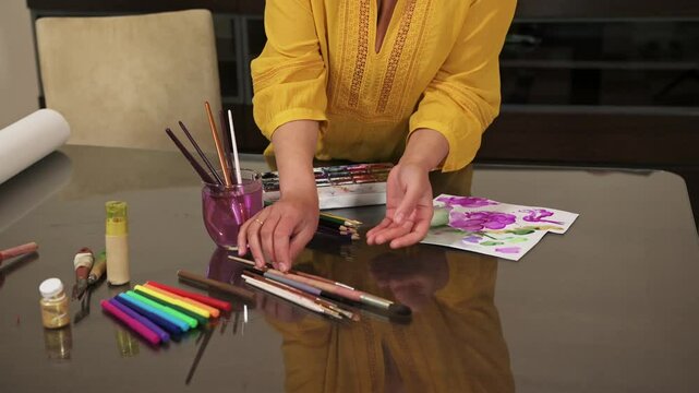 Woman Painting with Watercolors and Pastels at Home Art Desk