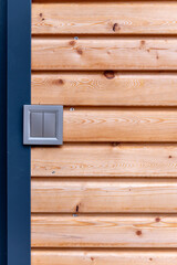 gray double light switch on the wall of wooden house