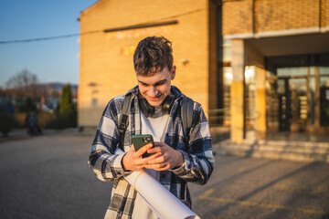 Obraz premium young man student stand in front university and use mobile phone