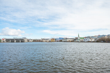 Skyline by lake Tjornin in city of Reykjavik in Iceland