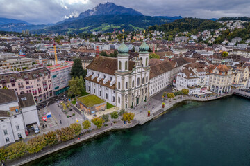 Fototapeta premium Stunning aerial footage of Kapellbrücke, the iconic Chapel Bridge, showcasing the picturesque beauty of Lucerne, Switzerland.