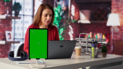 Woman organizing and planning activities on the agenda next to chroma key, overseeing time management for the schedule by using online tools as weekly planner and digital calendar. Camera A.