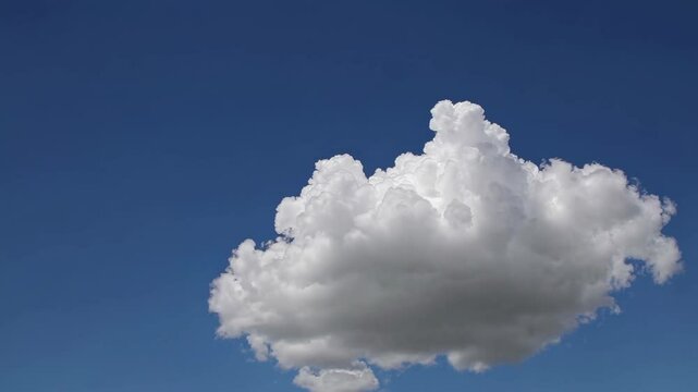 A single fluffy cloud floats against a clear blue sky, captured from a low-angle perspective, evoking a serene, minimalist video aesthetic. Live desktop wallpaper.