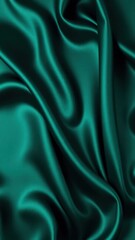 Obraz premium Dark teal green silk satin. Shiny smooth fabric. Soft folds. Luxury background with space for design. web banner. Flat lay, top view table. Birthday, Christmas, Valentine, New year.