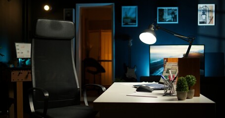 Contemporary loft style apartment with a homey office corner. Wooden floors, decorative plants and a TV creating a stylish comfortable and creative urban space for work and relaxation.