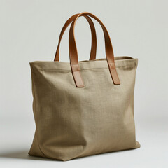 Stylish beige tote bag with brown leather handles, perfect for everyday use.