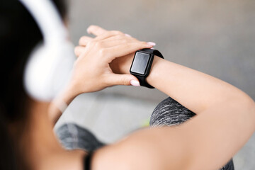 Fitness Tracker. Unrecognizable Woman Checking Her Sport Progress On Smartwatch After Training Outdoors, Over Shoulder View With Selective Focus