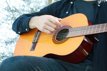 Fototapeta premium Playing the Guitar Outdoor to Train the Mind for Concentration and Exercise