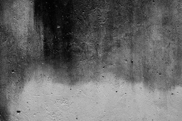 Dark, weathered concrete surface with rough textures and organic patterns, evoking a sense of decay...