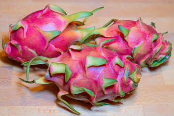 Vibrant, close up focus-stacked group of tropical, colorful, flavorful, fresh, sweet, juicy and succulent berries known as the Dragon Fruit cacti fresh from farmer&rsquo;s market
