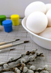 Chicken eggs in a bowl, paints, brushes, willow