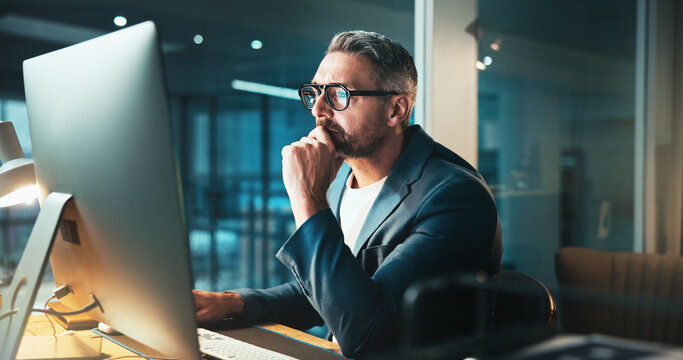 Man, programmer and thinking with computer at night for server programming, software update or deadline. Mature person, online and it for research of problem solving, system error and website upgrade - Powered by Adobe