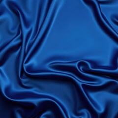 Fototapeta premium Beautiful dark blue silk satin background. Soft folds on shiny fabric. Luxury background with space for design. Web banner. Flat lay, Table top view. Christmas, Valentine's Day.