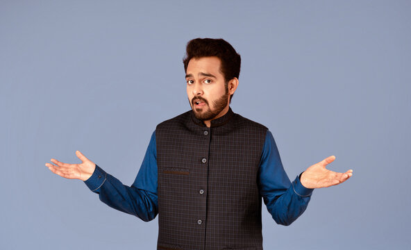 Who knows. Confused Indian guy shrugging shoulders on violet background, panorama
