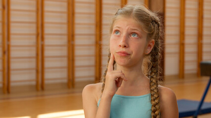 Sad pensive thoughtful girl teen kid child student pupil schoolgirl daughter athlete unhappy upset...