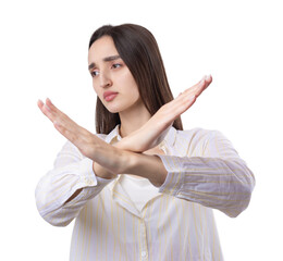 Portrait of a serious young woman showing stop gesture with her palm over white background