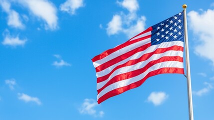 Obraz premium American Flag Waving on a Sunny Day with Blue Sky and Clouds