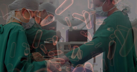 Multiple blood vessels floating against team of surgeons performing surgery at hospital