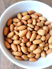 A bowl filled with fresh almonds, creating a wholesome and nutritious snack or ingredient concept.
