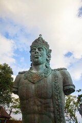 Obraz premium Half-body statue of Vishnu in the Garuda Wisnu Kencana complex in Bali Indonesia. In Hinduism, Vishnu is a god who is titled as shtiti, the maintainer of God's creation.