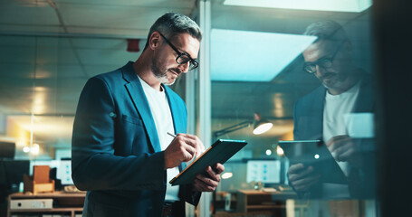 Mature programmer, tablet and stylus with report, overtime work or project email review. Web...