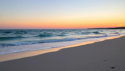 Serene beach scene at sunset with gentle waves and soft sand.