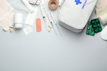 Flat lay composition with first aid kit on gray background, space for text