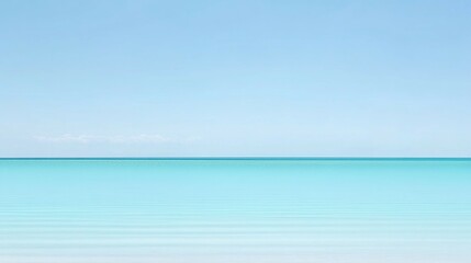Fototapeta premium Calm ocean water meets the bright blue sky in a peaceful scene