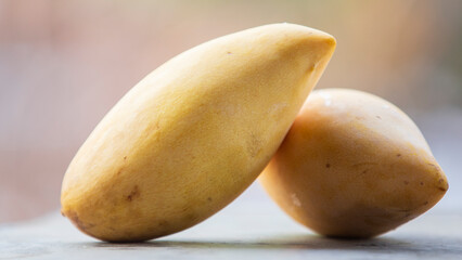 Ripe mango fruit on wooden table