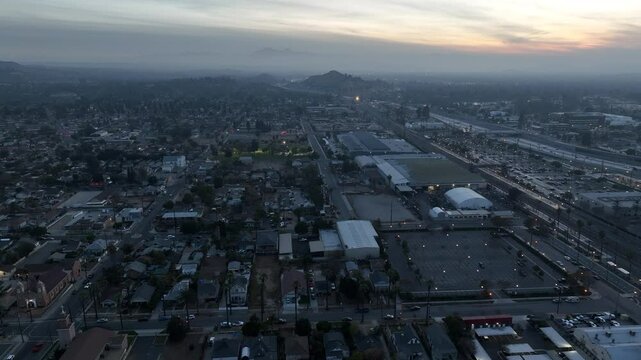 Riverside, California, USA - December 31, 204: A train pulls into the Downtown Train Station and traffic passes on the 91 freeway.
