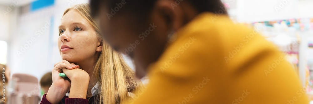 Fototapete Students in a classroom setting, focused and attentive. Diverse classroom environment with students engaged in learning activities, showing concentration and interest. Education and knowledge.