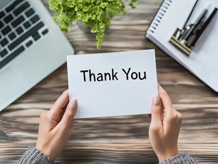 Woman's Hands Hold Thank You Note at Desk.