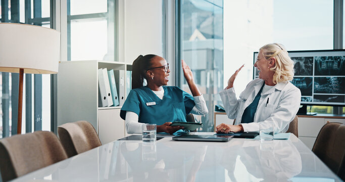 High five, doctor and medical student in hospital with xray for surgery planning in collaboration. Women, technology and mature surgeon with healthcare intern for teaching treatment with MRI scan. - Powered by Adobe