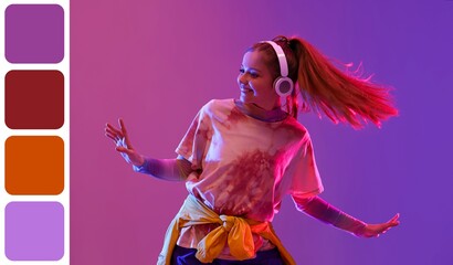 Happy woman in headphones dancing hip-hop on dark purple background. Different color patterns