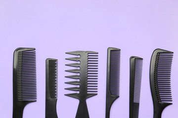 Hairdresser's brushes on lilac background