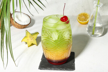 Fresh summer cocktail with cherry on white table