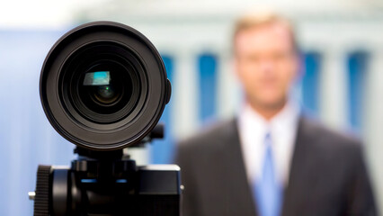 Public Policy concept. Camera lens focused on a blurred figure in a suit, creating a professional atmosphere.
