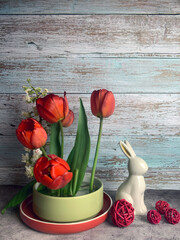 spring easter still life with hare, red tulips and blossoming chestnut