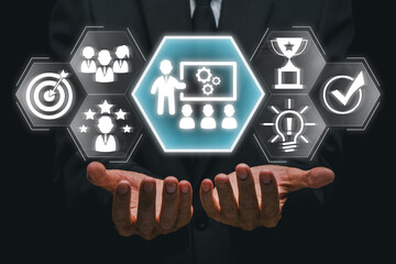 Hands presenting digital icons symbolizing a business workshop, teamwork, innovation, and success...
