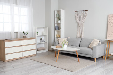 Stylish sofa with table in living room