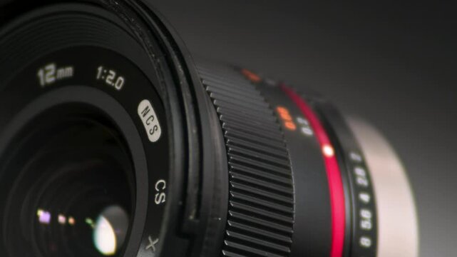 Close-up of a 12mm Camera Lens with Colorful Reflections