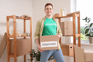 Male volunteer with donations in center