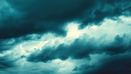 Obraz premium Dramatic blue green sky. Gloomy heavy thunderclouds. Dark teal sky background with copy space for design.