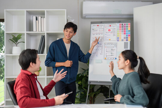 Interactive UI Presentation. A presenter engages the team while showcasing design layouts and features.