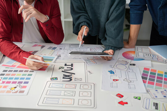 Creative Meeting and UIUX Strategy. Design professionals refining concepts and presentations together.