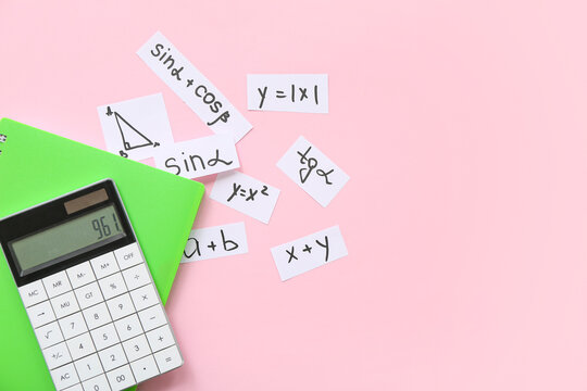 Notebook, calculator, different math formulas and equations on pink background