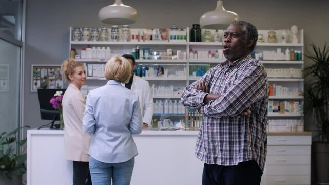 Impatient senior man waiting at pharmacy counter