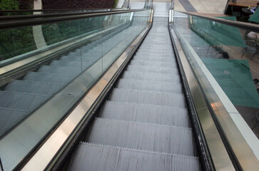 A POINT OF VIEW SHOT of a person going down an escalator.