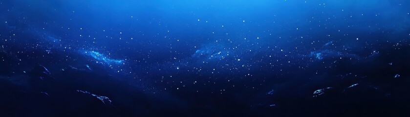 A deep, dark blue sky is adorned with countless twinkling stars, creating a serene night scene. A brilliant, luminous light shines brightly, illuminating the surrounding darkness.